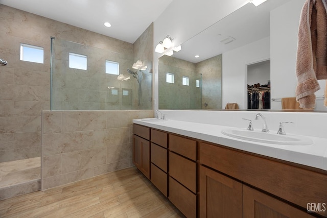9003 Del Palma Dr, Bakersfield, CA 93314 - bathroom featuring walk in shower, double vanity, wood finished floors, and a spacious closet