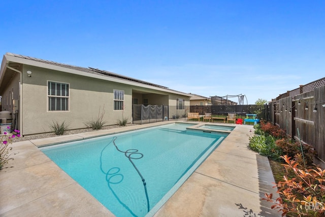 9003 Del Palma Dr, Bakersfield, CA 93314 - view of swimming pool with a fenced backyard, a pool with connected hot tub, and a trampoline