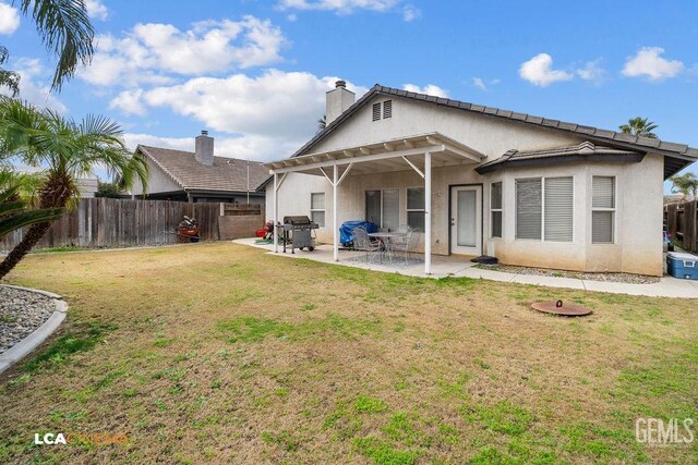 back of property featuring a patio area and a lawn