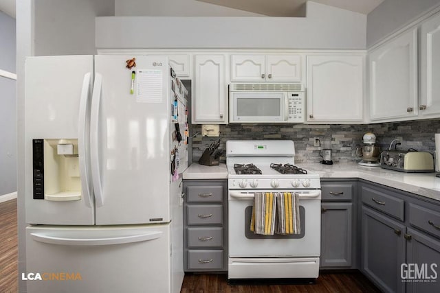 kitchen with gray cabinets, decorative backsplash, dark hardwood / wood-style floors, white appliances, and white cabinets