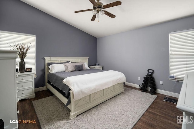 bedroom featuring ceiling fan, dark wood-type flooring, and lofted ceiling