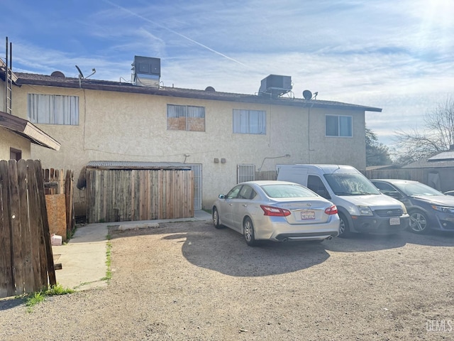 rear view of property featuring central air condition unit