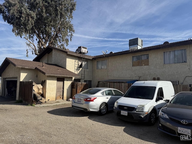 view of front of property with a garage and central AC