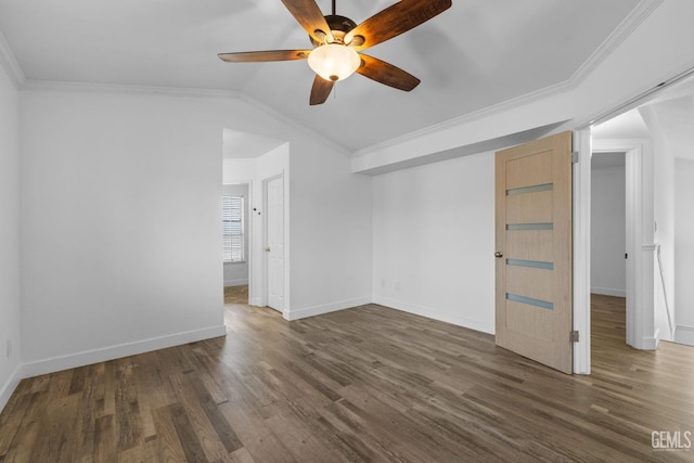 empty room featuring wood finished floors, baseboards, and ornamental molding