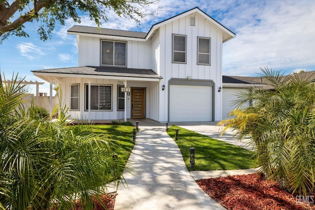 modern farmhouse with a porch, driveway, board and batten siding, and an attached garage