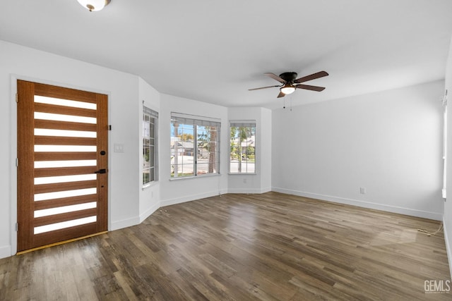 entrance foyer with a ceiling fan, baseboards, and wood finished floors