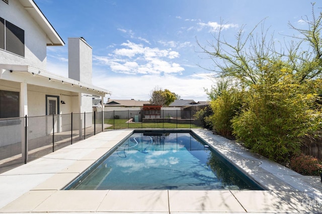 view of pool with a fenced in pool, a fenced backyard, and a lawn