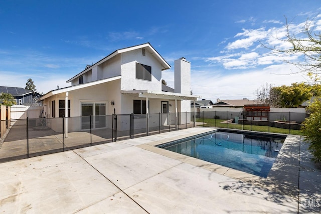 view of swimming pool with a patio area, a fenced in pool, a playground, and a fenced backyard