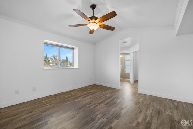 spare room featuring a healthy amount of sunlight, crown molding, baseboards, and wood finished floors