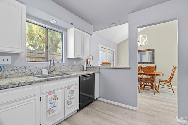 kitchen with black dishwasher, white cabinetry, light wood-style flooring, and a sink