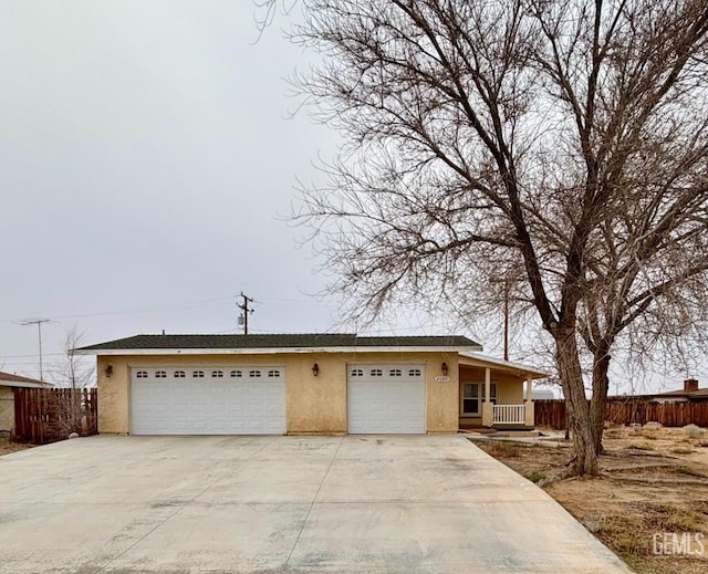 view of front of home with concrete driveway, stucco siding, and an attached garage