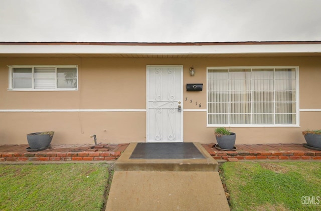 doorway to property with stucco siding