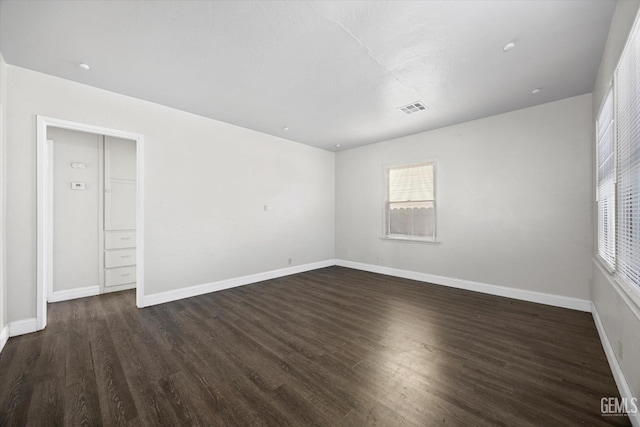 unfurnished room with dark hardwood / wood-style flooring