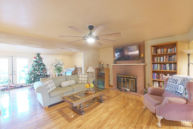 1041 Golden Gate Ave, Dos Palos, CA 93620 - living room with french doors, a brick fireplace, ceiling fan, and wood finished floors