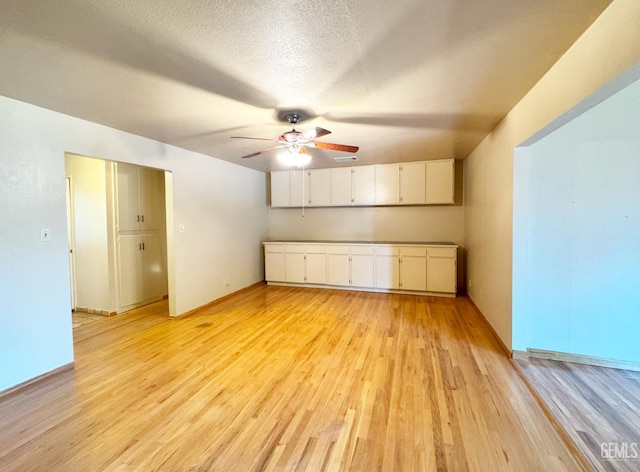 1041 Golden Gate Ave, Dos Palos, CA 93620 - spare room featuring ceiling fan, light wood-type flooring, and a textured ceiling