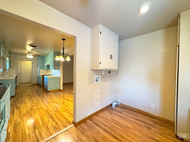 1041 Golden Gate Ave, Dos Palos, CA 93620 - laundry room featuring light wood-style flooring, ceiling fan, a chandelier, and washer hookup