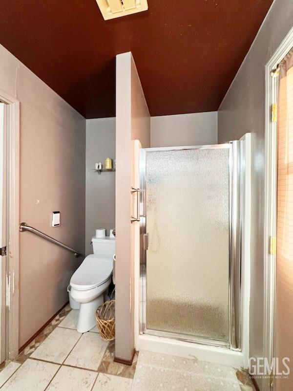 1041 Golden Gate Ave, Dos Palos, CA 93620 - bathroom featuring tile patterned floors, a shower stall, and toilet