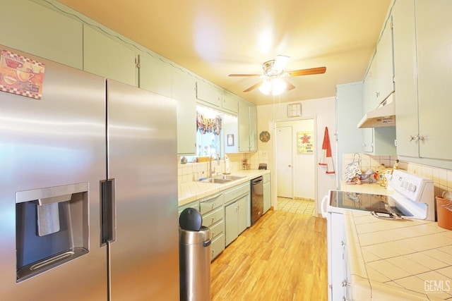1041 Golden Gate Ave, Dos Palos, CA 93620 - kitchen featuring electric range, black dishwasher, stainless steel refrigerator with ice dispenser, tile countertops, and a sink