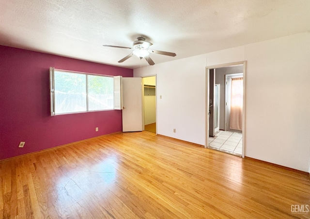 1041 Golden Gate Ave, Dos Palos, CA 93620 - unfurnished bedroom with light wood-style floors, ceiling fan, and a spacious closet