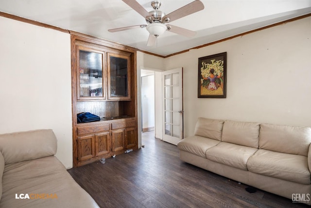 living room with ornamental molding, ceiling fan, and dark wood-style flooring