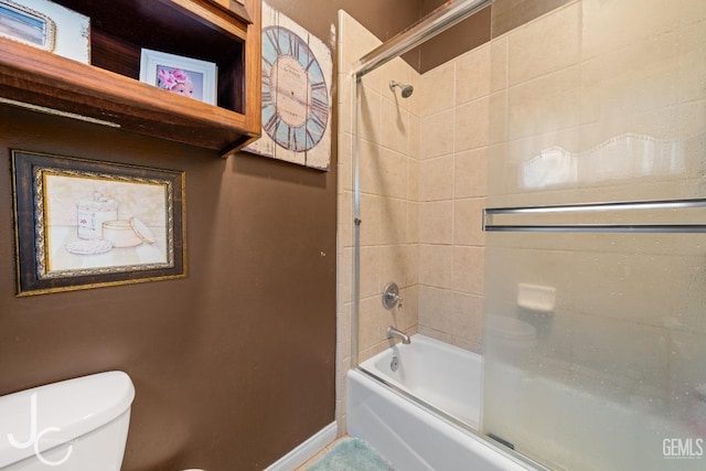 full bath with washtub / shower combination, toilet, and baseboards