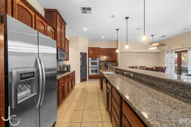 kitchen featuring visible vents, a ceiling fan, light tile patterned floors, tasteful backsplash, and appliances with stainless steel finishes