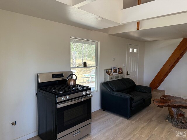 0 Rancheria Rd, Bakersfield, CA 93306 - kitchen with stainless steel gas range oven, light wood-type flooring, and open floor plan