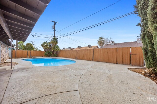 view of swimming pool featuring a patio, a fenced backyard, and a fenced in pool