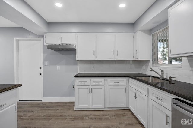 kitchen with dishwasher, white cabinetry, a sink, and wood finished floors