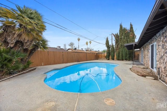 view of swimming pool featuring a patio area, a fenced backyard, and a fenced in pool