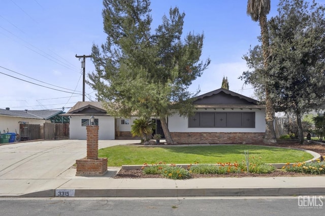 single story home featuring fence, a front lawn, concrete driveway, and brick siding