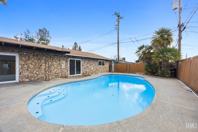 view of pool featuring a patio area, a fenced backyard, and a fenced in pool