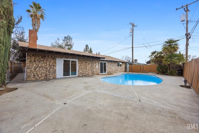 view of swimming pool with a patio area, a fenced backyard, and a fenced in pool