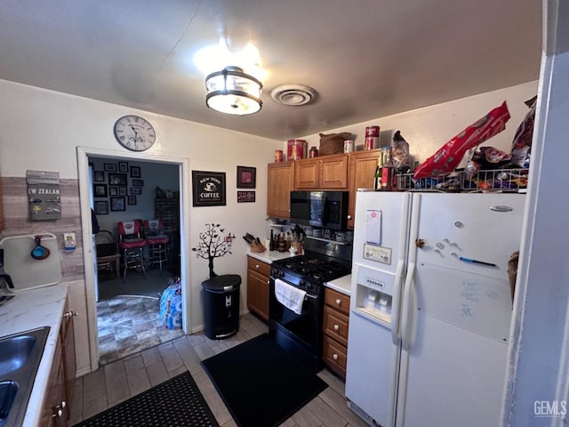 kitchen with sink and black appliances