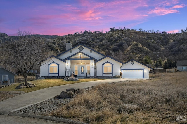 view of front of property featuring a garage and a mountain view