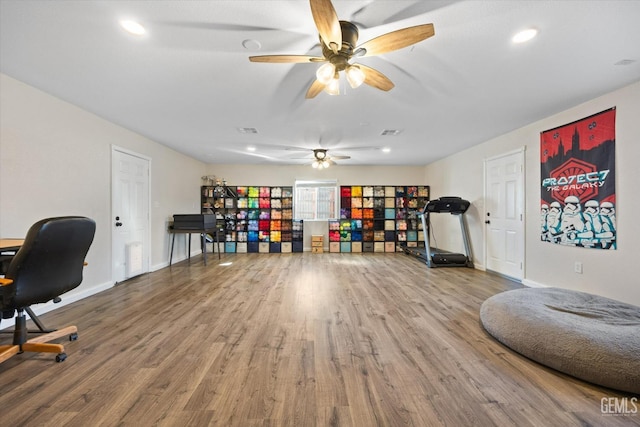 interior space with wood-type flooring and ceiling fan