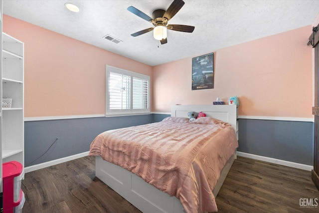 bedroom featuring dark wood-type flooring and ceiling fan