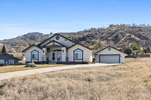 single story home featuring a garage and a mountain view