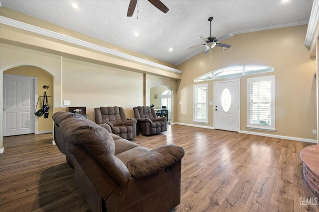 living room with crown molding, ceiling fan, wood-type flooring, a textured ceiling, and vaulted ceiling