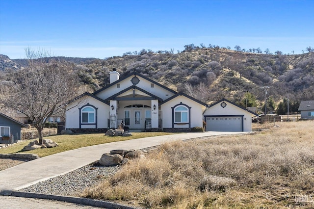 single story home featuring a garage and a mountain view