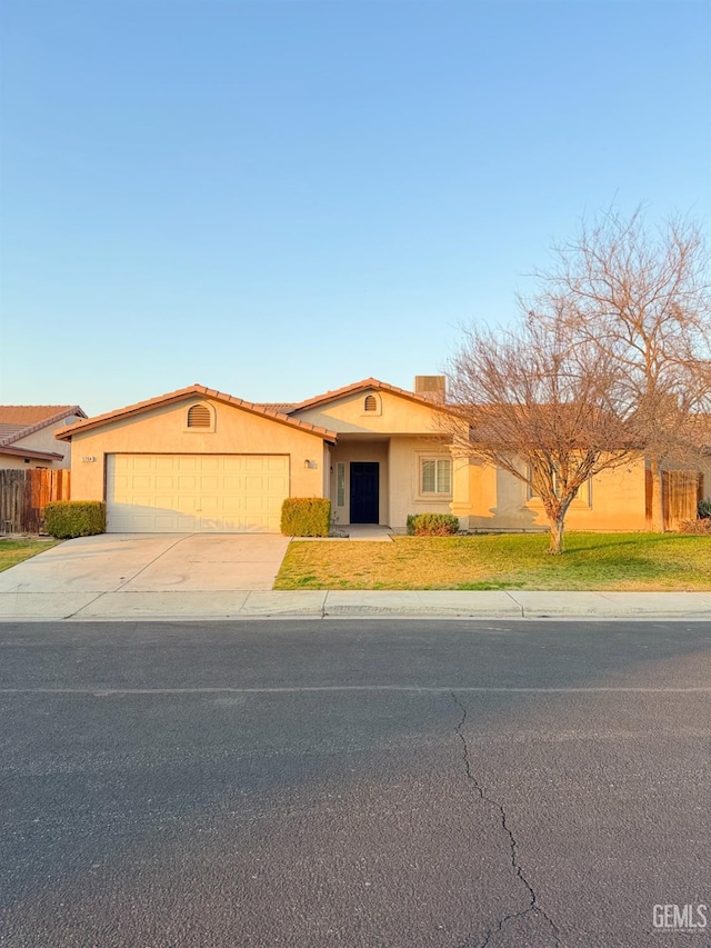 view of front of house with a garage and a front lawn