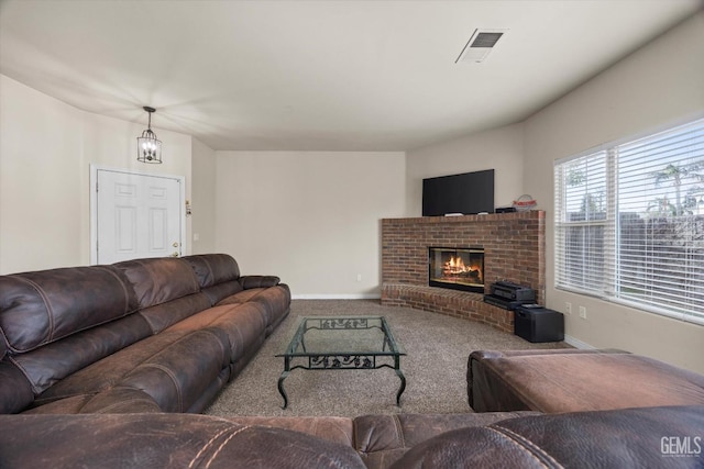 carpeted living area with a brick fireplace, visible vents, and baseboards