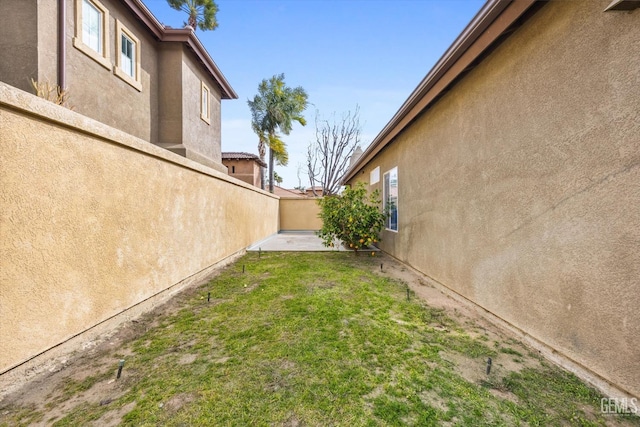 view of yard featuring fence and a patio