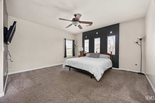 carpeted bedroom featuring baseboards, visible vents, and a ceiling fan