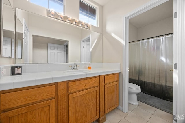 bathroom with a shower with curtain, vanity, toilet, and tile patterned floors