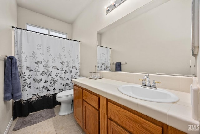 full bathroom with tile patterned flooring, a shower with curtain, vanity, and toilet