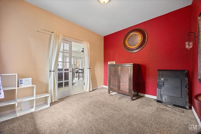 misc room featuring heating unit, carpet flooring, and baseboards