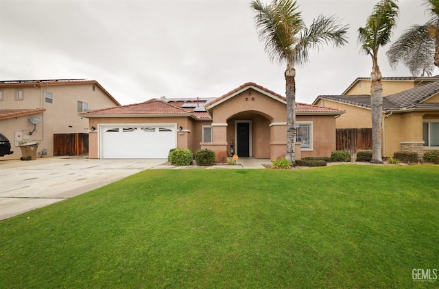 mediterranean / spanish-style house with a garage, a front lawn, and solar panels