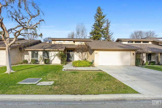 view of front of house featuring a garage, stucco siding, concrete driveway, and a front yard