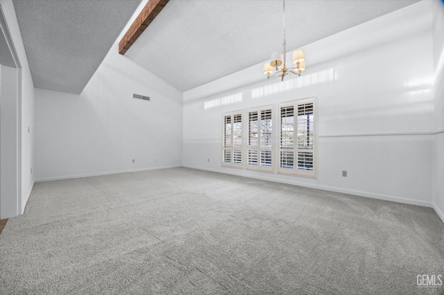 empty room featuring a textured ceiling, carpet flooring, and visible vents